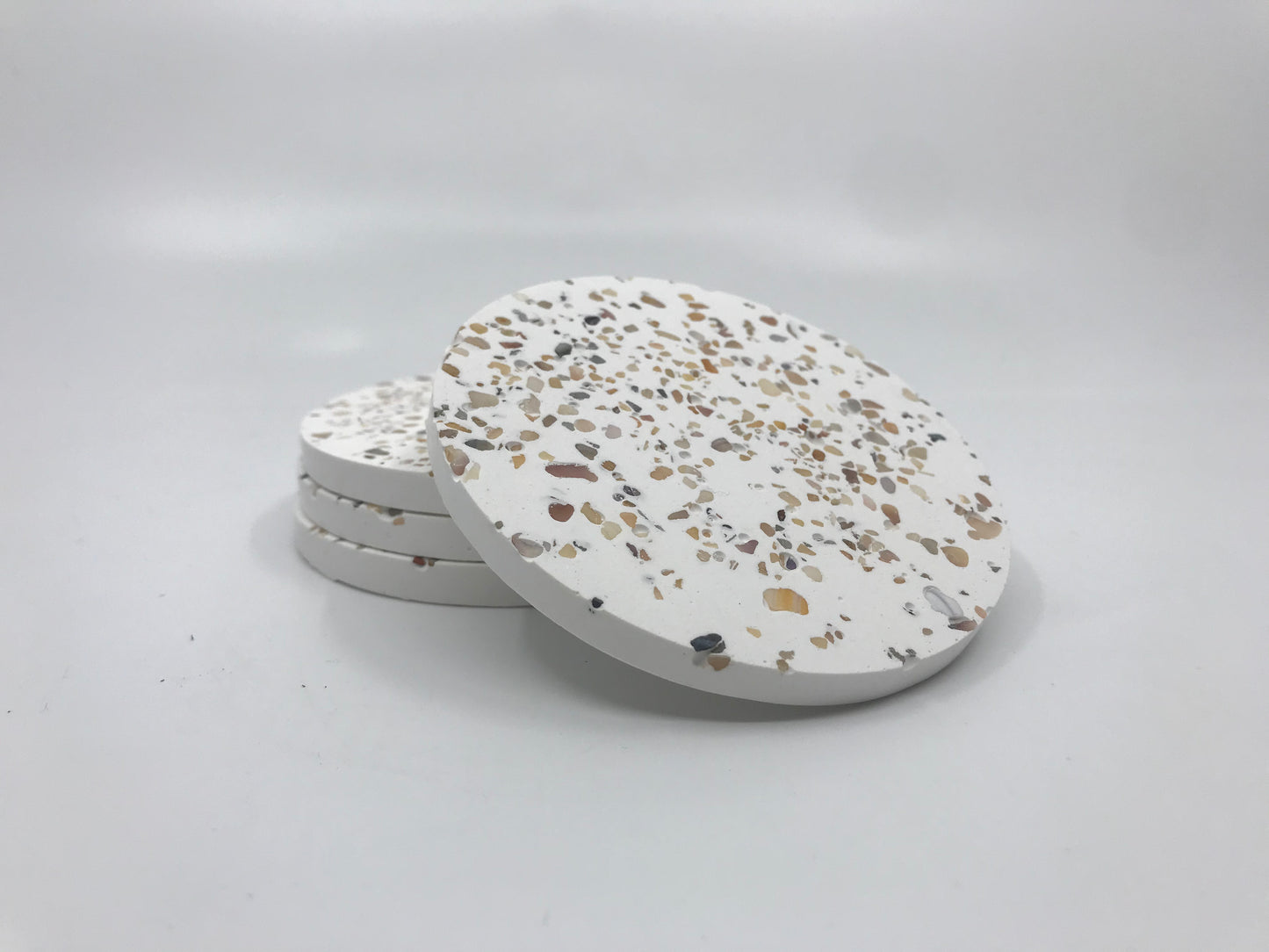 Terrazzo patterned coasters on a white background