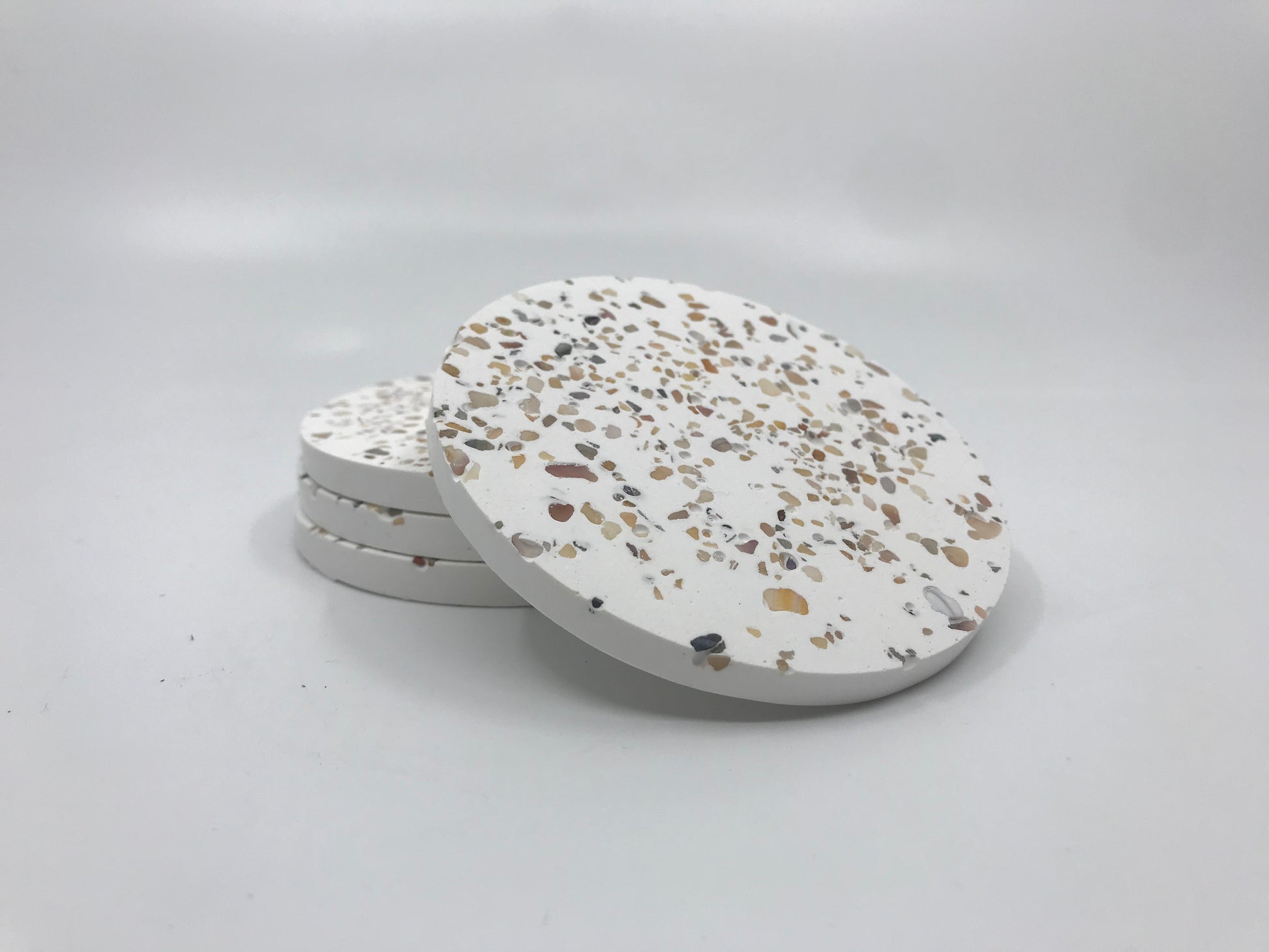 Terrazzo patterned coasters on a white background